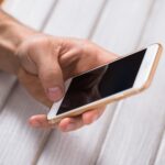 Close up of a man using mobile smart phone